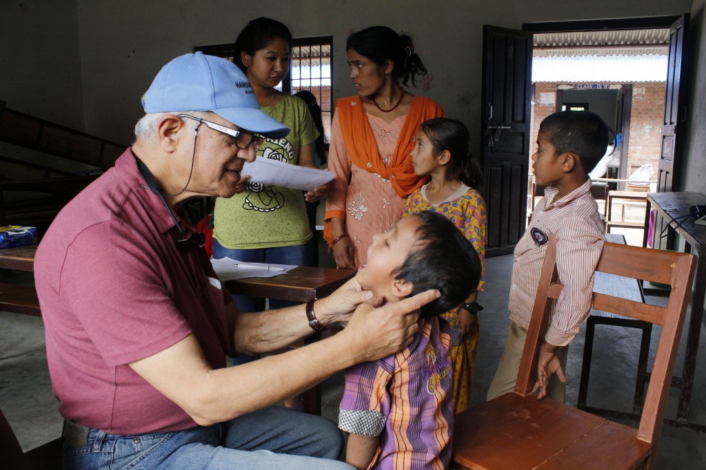 Dr. Banskota examining a patient at an earthquake relief clinic